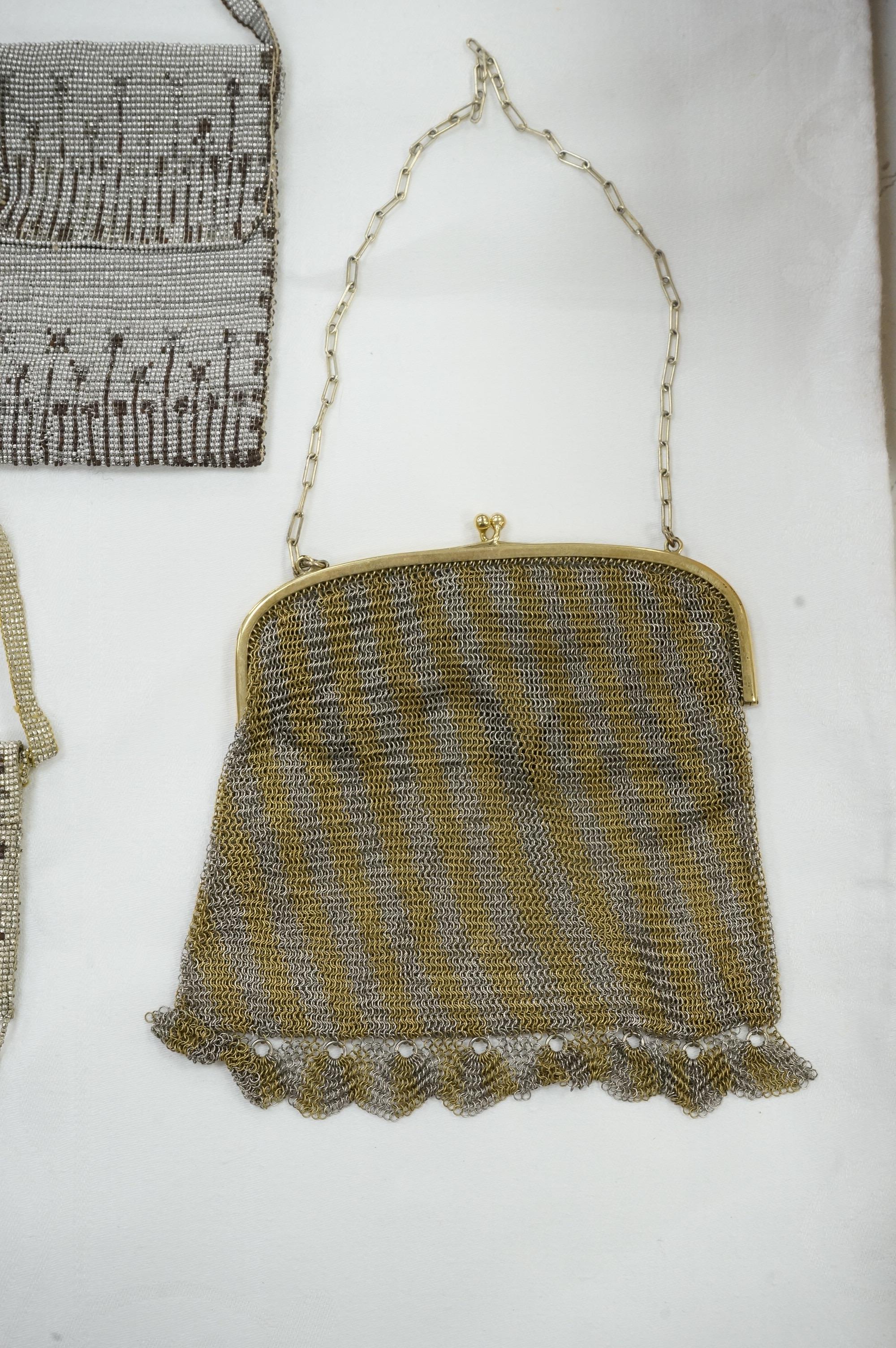 An Art Deco coloured metal chain mail evening bag together with a silver metal bead, blue clasped evening bag and smaller purse., Chain mail bag 13.5cm high. Condition - good on all three.